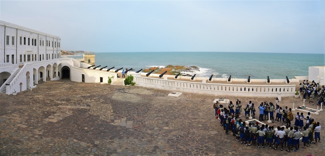 Inside the castle. Group of visitors on tour, standing in front of the grave of an British colonial governor and his wife. (c) Photo by Remo, Cape Coast Castle