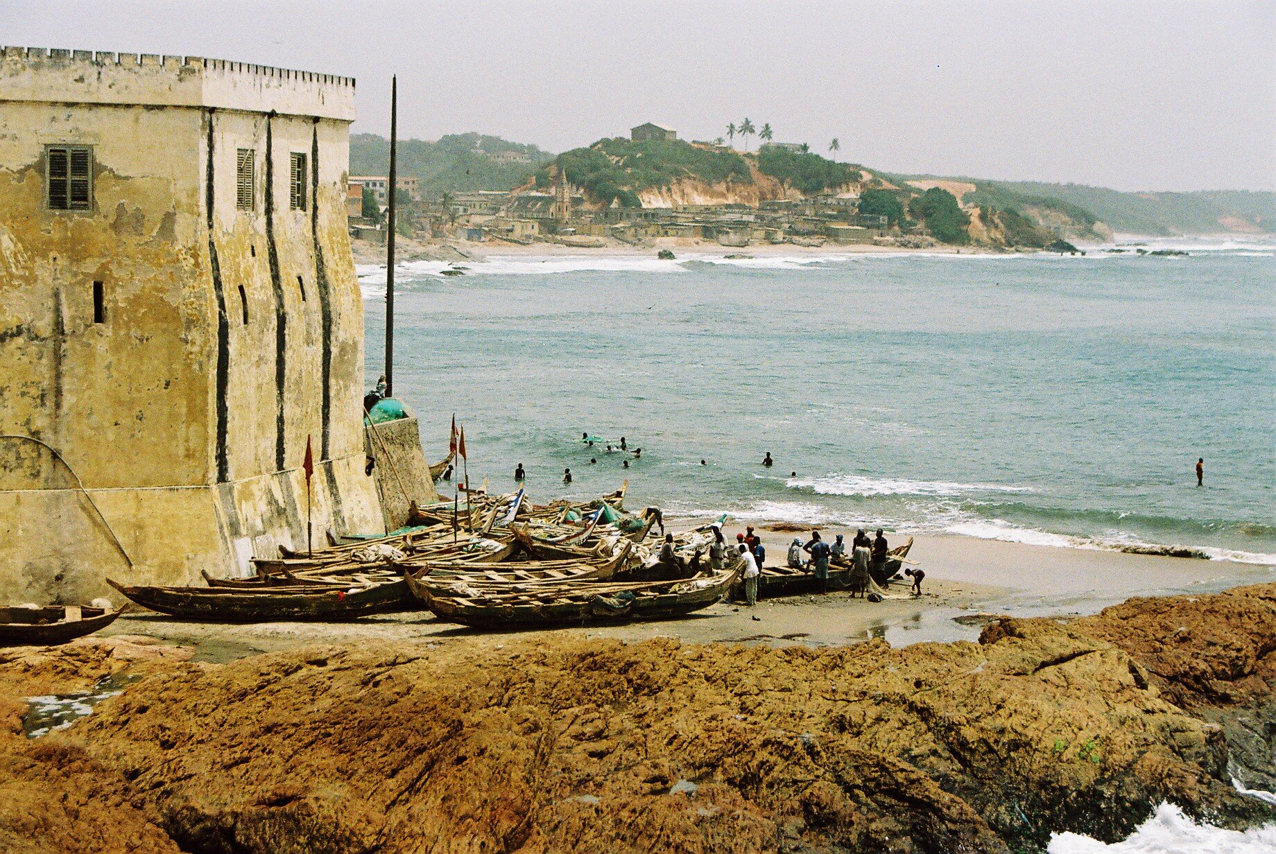 Fishing boats at the walls of Slave Trading Cape Coast castle